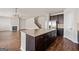 Open concept kitchen with a large island, view of the living room and staircase at 7754 Hansel Ln, Lithonia, GA 30058