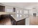 Well-lit kitchen with granite countertops, dark cabinets, and a view to the living room at 7754 Hansel Ln, Lithonia, GA 30058