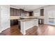 Stylish kitchen with dark cabinets, granite countertops, and stainless steel appliances at 7754 Hansel Ln, Lithonia, GA 30058