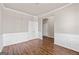 Bright and spacious living room featuring wood floors, wainscoting, and neutral color palette at 7754 Hansel Ln, Lithonia, GA 30058