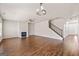 Large living room featuring a fireplace, stairs to the upper level, and hardwood floors at 7754 Hansel Ln, Lithonia, GA 30058