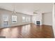 Spacious living room with a fireplace, many windows, and hardwood floors at 7754 Hansel Ln, Lithonia, GA 30058
