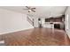 Open floor plan with hardwood floors connecting the living room and kitchen area at 7754 Hansel Ln, Lithonia, GA 30058