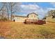 House featuring a spacious backyard with a wooden deck and ample space for outdoor recreation at 4161 Windermere Dr, Lithonia, GA 30038
