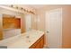 Bathroom featuring a large mirror, spacious counter, and a sink, complemented by storage at 4161 Windermere Dr, Lithonia, GA 30038