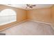 Bedroom featuring carpeted flooring, a ceiling fan, neutral walls, and a large window at 4161 Windermere Dr, Lithonia, GA 30038