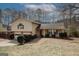 Charming split-level home with a well-maintained lawn, mature trees, and a two-car garage at 4161 Windermere Dr, Lithonia, GA 30038