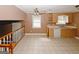 Open-concept kitchen and dining area with tile flooring, ceiling fan, and natural light at 4161 Windermere Dr, Lithonia, GA 30038