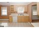 A bright kitchen featuring ample cabinet space, a double sink, and a white dishwasher at 4161 Windermere Dr, Lithonia, GA 30038