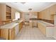 Functional kitchen features ample counter space, tile flooring, and a mosaic tile backsplash at 4161 Windermere Dr, Lithonia, GA 30038
