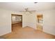 Bright living room with ceiling fan, wainscotting and a view into other rooms at 4161 Windermere Dr, Lithonia, GA 30038