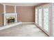 Spacious living room featuring a fireplace and access to the exterior through glass-paneled doors at 4161 Windermere Dr, Lithonia, GA 30038