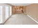 Open living space featuring doors, stairs, kitchen view, and ample natural light at 4161 Windermere Dr, Lithonia, GA 30038