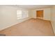 Open living room has large windows providing ample natural light and a neutral carpet at 4161 Windermere Dr, Lithonia, GA 30038