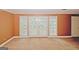 A living room with sliding glass doors and neutral carpet provides a bright and versatile living space at 4161 Windermere Dr, Lithonia, GA 30038