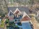 Stunning brick home with well-maintained landscaping, three car garage, and inviting front porch at 1654 Summersweet Ln, Dacula, GA 30019
