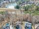 Aerial view showing a house with a pool backing up to a lush neighborhood lake and mature trees at 1654 Summersweet Ln, Dacula, GA 30019