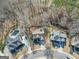 Aerial view of neighborhood highlighting mature trees, inground pool, and spacious lots at 1654 Summersweet Ln, Dacula, GA 30019