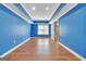 Finished basement with recessed lights, hardwood floors, and blue walls at 1654 Summersweet Ln, Dacula, GA 30019