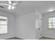 Cozy carpeted bedroom features two windows, a ceiling fan, and a closet at 1654 Summersweet Ln, Dacula, GA 30019
