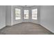 Bright bedroom with neutral carpet and three large windows at 1654 Summersweet Ln, Dacula, GA 30019