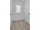 Small carpeted bedroom with white walls has a window, baseboards and two doors at 1654 Summersweet Ln, Dacula, GA 30019