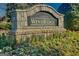 Stone community sign for Windridge at Hamilton Mill, surrounded by landscaped greenery and seasonal color at 1654 Summersweet Ln, Dacula, GA 30019