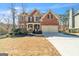 Charming two-story brick home with a two-car garage, mature trees, and a well-maintained lawn at 1654 Summersweet Ln, Dacula, GA 30019