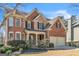 Traditional brick home with attached two-car garage and professionally landscaped front yard at 1654 Summersweet Ln, Dacula, GA 30019