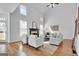 Bright living room with soaring ceilings, a fireplace, and large windows allowing ample natural light at 1654 Summersweet Ln, Dacula, GA 30019