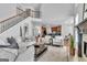 Open floor plan living room with fireplace, hardwood floors, and staircase at 1654 Summersweet Ln, Dacula, GA 30019