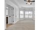 Spacious primary bedroom with neutral carpet, a tray ceiling and a bright bay window at 1654 Summersweet Ln, Dacula, GA 30019
