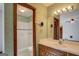 Bathroom featuring a single sink vanity and a shower/tub combo with green wallpaper at 825 Sugar Creek Se Way, Conyers, GA 30094