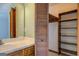 Bathroom featuring vintage single sink vanity, large mirror, and closet at 825 Sugar Creek Se Way, Conyers, GA 30094