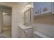 Bathroom featuring a white vanity, seashell decor and a mirrored cabinet with storage at 825 Sugar Creek Se Way, Conyers, GA 30094