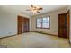 Carpeted bedroom with a ceiling fan, window, and closet at 825 Sugar Creek Se Way, Conyers, GA 30094