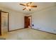 Bedroom featuring a ceiling fan, neutral carpet and view to the bathroom at 825 Sugar Creek Se Way, Conyers, GA 30094