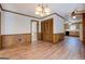 Open dining room with wood floors, wainscoting, and ample space, flowing into kitchen and other living areas at 825 Sugar Creek Se Way, Conyers, GA 30094