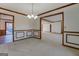 Bright dining room with wainscoting and a chandelier, transitions seamlessly to other living areas and the outdoors at 825 Sugar Creek Se Way, Conyers, GA 30094