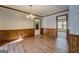 Elegant dining room with wood floors and wainscoting, offering a seamless transition to adjacent rooms at 825 Sugar Creek Se Way, Conyers, GA 30094