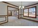 Dining room with wainscoting, chandelier, and large windows, perfect for meals and gatherings overlooking outdoor scenery at 825 Sugar Creek Se Way, Conyers, GA 30094