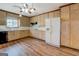 Bright kitchen featuring wood cabinets, white appliances, and wood-look floors at 825 Sugar Creek Se Way, Conyers, GA 30094