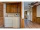 Laundry room features a washer, dryer, and built-in cabinetry with a view into the kitchen at 825 Sugar Creek Se Way, Conyers, GA 30094