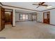 Light-filled living room with neutral carpet, wood trim, and large windows offering a bright and inviting space at 825 Sugar Creek Se Way, Conyers, GA 30094