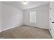 Bedroom featuring neutral paint, carpet, one window and door at 789 Galveston Way, Mcdonough, GA 30253