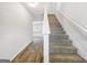 Inviting entryway with a staircase, showcasing carpeted steps and sleek flooring at 789 Galveston Way, Mcdonough, GA 30253