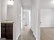 Hallway view showcasing neutral walls and carpeting, leading to various rooms at 789 Galveston Way, Mcdonough, GA 30253