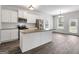 Modern kitchen featuring white cabinets, granite countertops, stainless steel appliances, and sleek flooring at 789 Galveston Way, Mcdonough, GA 30253