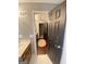 Open bathroom featuring wood floors, light walls, a ceiling fan, and an entrance to another room at 848 Still Rd, Lawrenceville, GA 30045