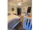 Bedroom with a crib, neutral walls, dark accents, and warm lamp lighting at 848 Still Rd, Lawrenceville, GA 30045